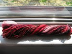 Red, brown, and white spun yarn thumbnail.