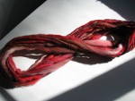 Red, brown, and white spun yarn thumbnail.