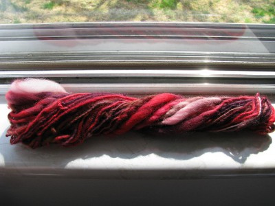 Red, brown, and white spun yarn.